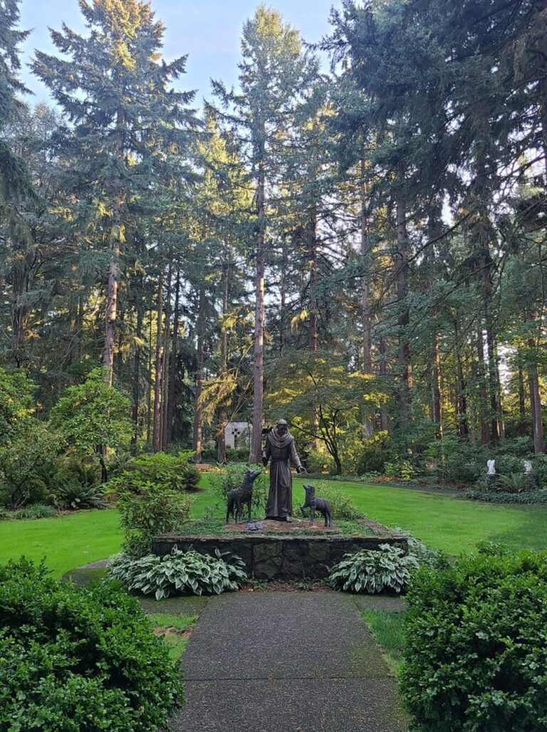 A photo of the St. Francis of Assisi Sculpture in The Grotto's gardens.